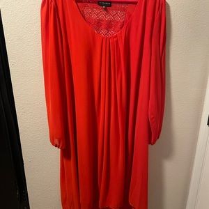 Long sleeve orange dress with lace back detail.